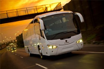 Un autobus bianco su una strada al tramonto